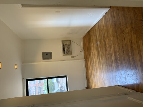 living room - wall through air conditioner. nice hard wood floors