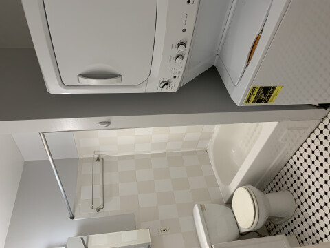 large renovated bathroom includes bath/showe and family-size washer/dryer