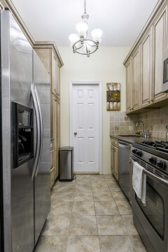kitchen - stainless steel appliances, granite counters, loads of storage, huge fridge/freezer